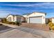 Well maintained home exterior, featuring a two-car garage and desert landscaping at 10712 E Trillium Ave, Mesa, AZ 85212