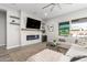 Cozy living room featuring a fireplace and sliding doors to the backyard at 10712 E Trillium Ave, Mesa, AZ 85212