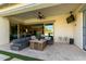 Covered patio with seating, fire pit, and TV at 10712 E Trillium Ave, Mesa, AZ 85212