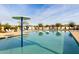 Community swimming pool with lounge chairs and a mushroom water feature at 10712 E Trillium Ave, Mesa, AZ 85212