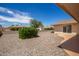 Landscaped backyard with gravel and a patio at 10714 W Saratoga Cir, Sun City, AZ 85351