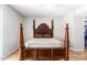 Bedroom with wood post bed and light flooring at 10714 W Saratoga Cir, Sun City, AZ 85351