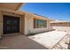 Front entry with decorative black door and gravel landscaping at 10714 W Saratoga Cir, Sun City, AZ 85351