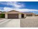 Ranch style home with a two-car garage and solar panels at 10714 W Saratoga Cir, Sun City, AZ 85351