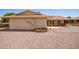 Back exterior of house showing a patio and gravel yard at 10714 W Saratoga Cir, Sun City, AZ 85351