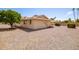 Side exterior view of house and a gravel yard at 10714 W Saratoga Cir, Sun City, AZ 85351