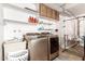 Laundry room with washer, dryer, and storage cabinets at 10714 W Saratoga Cir, Sun City, AZ 85351