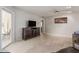 Living area with gray sofas, hardwood floors, and kitchen view at 10714 W Saratoga Cir, Sun City, AZ 85351