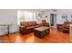 Living room with leather sofas, coffee table, and hardwood floors at 10714 W Saratoga Cir, Sun City, AZ 85351