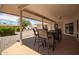 Covered patio with seating area, overlooking a gravel backyard at 10714 W Saratoga Cir, Sun City, AZ 85351