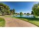 Landscaped pond with fountain and walking path at 10714 W Saratoga Cir, Sun City, AZ 85351