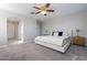 Spacious bedroom with plush carpet and ceiling fan at 1080 S 151St Ln, Goodyear, AZ 85338