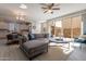 Living room with sectional sofa, large windows, and access to backyard at 1080 S 151St Ln, Goodyear, AZ 85338