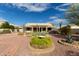 Landscaped backyard oasis with a covered patio and desert plants at 10949 W Sierra Pinta Dr, Peoria, AZ 85373