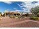 Backyard with covered patio, artificial turf, and desert landscaping at 10949 W Sierra Pinta Dr, Peoria, AZ 85373