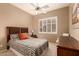 Guest bedroom with ceiling fan and window shutters at 10949 W Sierra Pinta Dr, Peoria, AZ 85373