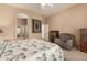 Main bedroom with ceiling fan and view into bathroom at 10949 W Sierra Pinta Dr, Peoria, AZ 85373