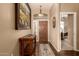 Inviting entryway with hardwood floors and a rustic console table at 10949 W Sierra Pinta Dr, Peoria, AZ 85373