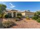 House exterior with three car garage and desert landscaping at 10949 W Sierra Pinta Dr, Peoria, AZ 85373