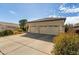 House exterior with a three-car garage and front yard landscaping at 10949 W Sierra Pinta Dr, Peoria, AZ 85373