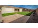 Artificial turf backyard with stone patio and view of home at 11005 E Texas Ave, Mesa, AZ 85212