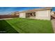 Artificial turf backyard with patio and partial home view at 11005 E Texas Ave, Mesa, AZ 85212