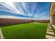 Artificial turf backyard with stone pathway at 11005 E Texas Ave, Mesa, AZ 85212