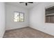 Well-lit bedroom featuring a large window and ceiling fan at 11005 E Texas Ave, Mesa, AZ 85212