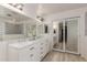 Modern bathroom with double vanity, walk-in shower, and mirrored closet at 11163 W Elm Ln, Avondale, AZ 85323