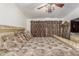 Bedroom with large bed, ceiling fan, and decorative curtains at 11163 W Elm Ln, Avondale, AZ 85323