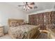 Large bedroom with ornate bed frame and ceiling fan at 11163 W Elm Ln, Avondale, AZ 85323