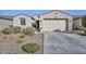 Single-story home with a two-car garage and well-manicured landscaping at 11618 W Levi Dr, Avondale, AZ 85323