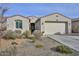 One-story home with a two-car garage and desert landscaping at 11618 W Levi Dr, Avondale, AZ 85323