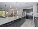 Modern kitchen with dark cabinetry and granite countertops at 11618 W Levi Dr, Avondale, AZ 85323