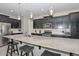 Modern kitchen with dark cabinetry, granite counters, and stainless steel appliances at 11618 W Levi Dr, Avondale, AZ 85323