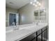 Bathroom with double sinks and modern light fixtures at 1255 N Arizona Ave # 1341, Chandler, AZ 85225