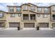 Tan three-story townhome with three-car garage and balcony at 1255 N Arizona Ave # 1341, Chandler, AZ 85225