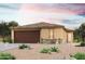 Tan stucco house with brown garage door, landscaping, and desert landscaping at 1443 W Hopi Dr, Coolidge, AZ 85128