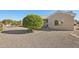 Backyard with gravel, mature tree, and patio at 14812 W Las Brizas Ln, Sun City West, AZ 85375