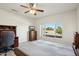 Bedroom with large bed, ceiling fan and window at 14812 W Las Brizas Ln, Sun City West, AZ 85375