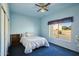 Bedroom with double bed, ceiling fan, and window at 14812 W Las Brizas Ln, Sun City West, AZ 85375