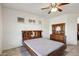 Bedroom with large bed, ceiling fan and window at 14812 W Las Brizas Ln, Sun City West, AZ 85375