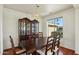 Spacious dining area with a large wood table, chairs, and china cabinet at 14812 W Las Brizas Ln, Sun City West, AZ 85375