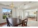 Bright dining room with a wood table and chairs, offering views to the living room at 14812 W Las Brizas Ln, Sun City West, AZ 85375