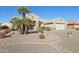 House exterior with palm trees and rock landscaping at 14812 W Las Brizas Ln, Sun City West, AZ 85375