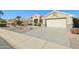 Front view of a house with a driveway and desert landscaping at 14812 W Las Brizas Ln, Sun City West, AZ 85375