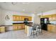 Modern kitchen with wood cabinets, granite countertops, and an island at 14812 W Las Brizas Ln, Sun City West, AZ 85375