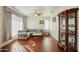 Living area with L-shaped sofa, wood floors, and display cabinet at 14812 W Las Brizas Ln, Sun City West, AZ 85375