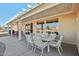 Outdoor patio with table, chairs, and lounge chairs at 14812 W Las Brizas Ln, Sun City West, AZ 85375