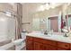 Clean bathroom with wood vanity and bathtub at 1577 E Laurel Dr, Casa Grande, AZ 85122